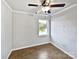 Simple bedroom with hardwood floors and a window at 8117 Aqueduct Ct, Charlotte, NC 28216