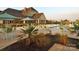 Community pool area with lounge chairs, tables, and umbrellas at 12724 Hazelbrook Ln, Cornelius, NC 28031