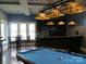 Basement game room with pool table, wet bar, and stained glass lighting at 12724 Hazelbrook Ln, Cornelius, NC 28031