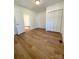Spacious bedroom with hardwood floors, large window, and closet at 112 Maple St, Shelby, NC 28150