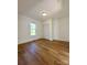 Bright bedroom with hardwood floors, window, and louvered closet doors at 112 Maple St, Shelby, NC 28150