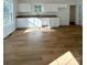 Bright kitchen features white cabinets, granite countertops, and light wood flooring at 112 Maple St, Shelby, NC 28150