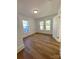 Bright bedroom with hardwood floors, two windows, and an open door at 112 Maple St, Shelby, NC 28150