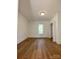 Bright bedroom with hardwood floors, large window, and closet with plantation shutters at 112 Maple St, Shelby, NC 28150
