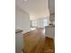 Open dining room with hardwood floors and large windows, adjacent to kitchen at 112 Maple St, Shelby, NC 28150