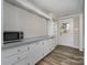 Bright kitchen with white cabinets, gray countertops, and stainless steel appliances at 807 Klondale Ave, Kannapolis, NC 28081
