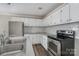 Modern kitchen with white cabinets and stainless steel appliances at 807 Klondale Ave, Kannapolis, NC 28081