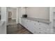 Kitchen features white cabinets and gray tile countertops at 807 Klondale Ave, Kannapolis, NC 28081