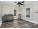 Bedroom with hardwood floors, ceiling fan, crib, and high chair at 807 Klondale Ave, Kannapolis, NC 28081