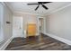 Bedroom with hardwood floors, ceiling fan, dresser, and access to other rooms at 807 Klondale Ave, Kannapolis, NC 28081