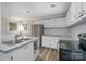 Kitchen boasts white cabinets, stainless steel appliances, and a breakfast bar at 807 Klondale Ave, Kannapolis, NC 28081