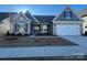 Two-story house with stone and blue siding, two-car garage, and landscaping at 8723 Acadia Pkwy # 617, Sherrills Ford, NC 28673