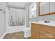 Clean bathroom with a shower/tub combo and oak vanity at 401 Ford St, Kannapolis, NC 28083