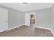 Bedroom with view into kitchen and wood-look floors at 401 Ford St, Kannapolis, NC 28083