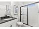 Modern bathroom with white subway tile, black accents, and a walk-in shower at 1395 Hubert Graham Way, Tega Cay, SC 29708