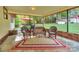 Relaxing screened porch with wicker furniture and brick floor at 459 Kenway Loop, Mooresville, NC 28117