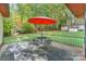 Small patio with metal table and chairs, and red umbrella at 459 Kenway Loop, Mooresville, NC 28117