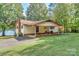 Ranch home with covered porch, brick patio, and lake view at 459 Kenway Loop, Mooresville, NC 28117