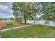 Scenic view of the lake with a dock and lush green landscape at 459 Kenway Loop, Mooresville, NC 28117