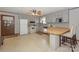 L-shaped kitchen with white appliances and light gray cabinets at 459 Kenway Loop, Mooresville, NC 28117