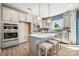 Modern kitchen with island, stainless steel appliances, and window at 1406 Hubert Graham Way, Tega Cay, SC 29708
