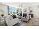 Open living space with fireplace, large windows and comfy seating at 1406 Hubert Graham Way, Tega Cay, SC 29708