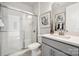 Modern bathroom with a walk-in shower and gray vanity at 1406 Hubert Graham Way, Tega Cay, SC 29708