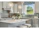 Bright kitchen boasts modern cabinetry and a stylish backsplash at 1406 Hubert Graham Way, Tega Cay, SC 29708
