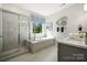 Spa-like bathroom with a soaking tub and walk-in shower at 1406 Hubert Graham Way, Tega Cay, SC 29708