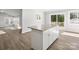 Modern kitchen features a large island with granite countertops and white cabinets at 709 Bringle Ferry Rd, Salisbury, NC 28144
