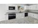Modern kitchen with granite countertops and white cabinets at 709 Bringle Ferry Rd, Salisbury, NC 28144