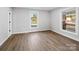 Well-lit bedroom with hardwood floors and a large window at 709 Bringle Ferry Rd, Salisbury, NC 28144