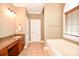 Bathroom with granite vanity, soaking tub, and tile flooring at 4108 Cheshire Glen Dr, Monroe, NC 28110