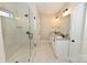Modern bathroom boasts dual vanities, a glass shower, and marble tile flooring at 4916 Southview Dr, Hickory, NC 28602
