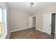 Bedroom with wood-look flooring, a window, and an open closet at 4916 Southview Dr, Hickory, NC 28602