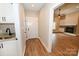 Hallway leading to a living room with a fireplace and built-in shelves at 4916 Southview Dr, Hickory, NC 28602