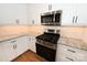 Close-up of stainless steel appliances and granite countertops in a modern white kitchen at 4916 Southview Dr, Hickory, NC 28602