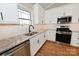 Modern kitchen with white shaker cabinets, granite countertops, stainless steel appliances, and ample natural light at 4916 Southview Dr, Hickory, NC 28602