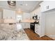 Stylish kitchen with white cabinets, granite countertops, stainless steel appliances, and a vaulted ceiling at 4916 Southview Dr, Hickory, NC 28602