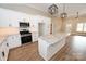 Spacious kitchen featuring white cabinetry, stainless steel appliances, a large island, and wood-look flooring at 4916 Southview Dr, Hickory, NC 28602