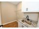 Laundry room with white cabinets, granite countertop, and utility sink at 4916 Southview Dr, Hickory, NC 28602