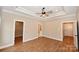 Main bedroom with a tray ceiling, walk-in closet, and ensuite bathroom access at 4916 Southview Dr, Hickory, NC 28602