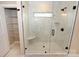 Spacious walk-in shower with marble tile, built-in seat, and window at 4916 Southview Dr, Hickory, NC 28602