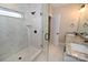 Walk-in shower with marble tile, a window, and black hardware at 4916 Southview Dr, Hickory, NC 28602