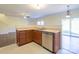 Kitchen features a double sink, dishwasher, and wooden cabinets at 8228 Weeping Fig Ln, Charlotte, NC 28215