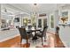 Bright dining room with a round table, hardwood floors, and a view to the backyard at 18935 Cloverstone Cir, Cornelius, NC 28031