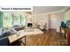 Living room with hardwood floors, fireplace, and large windows at 5072 Silver Creek Ln, Denver, NC 28037