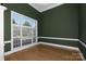 Home office with dark green walls, hardwood floors, and large window at 639 Deberry Holw, Rock Hill, SC 29732