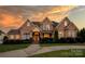 Brick house exterior at dusk, showcasing a large front yard and landscaping at 639 Deberry Holw, Rock Hill, SC 29732