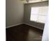 Bright bedroom with dark hardwood floors and window at 141 Rock Ridge Ln, Mount Holly, NC 28120